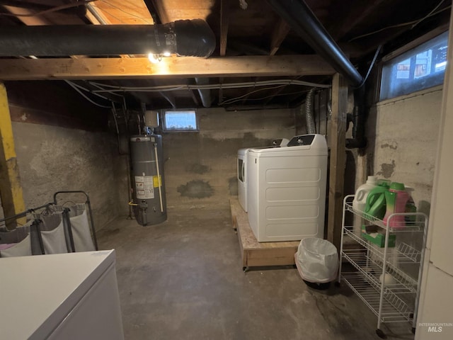 basement featuring separate washer and dryer, water heater, and refrigerator