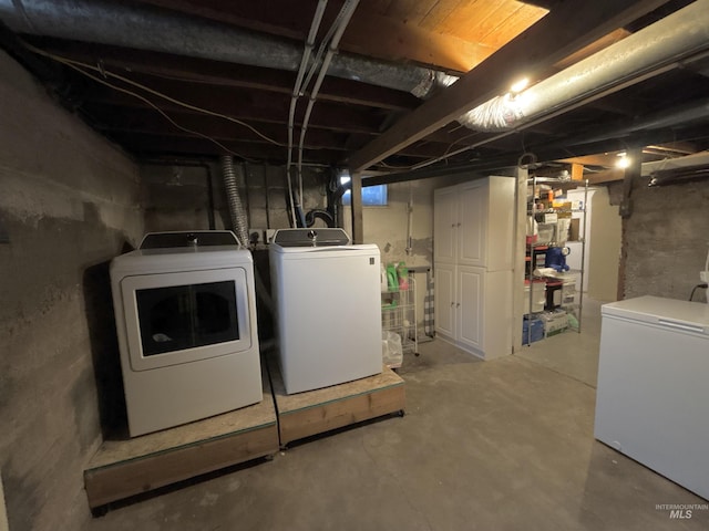 basement with refrigerator and washing machine and dryer