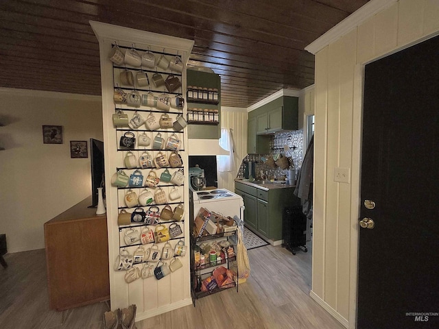 kitchen featuring light hardwood / wood-style floors, wooden ceiling, and green cabinets