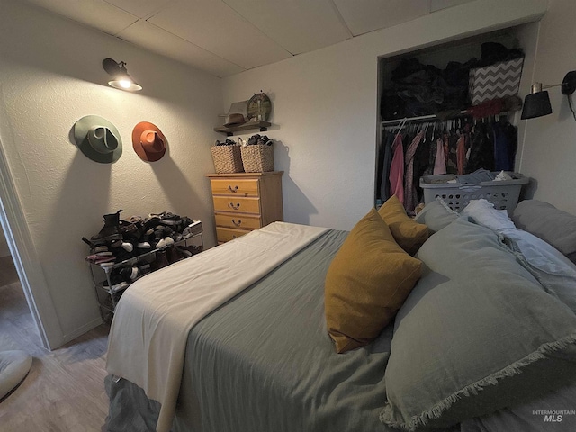 bedroom with wood-type flooring and a closet