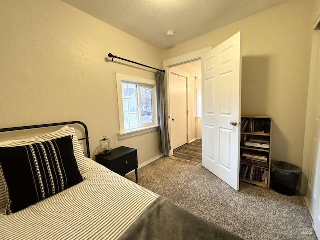 carpeted bedroom featuring a textured ceiling