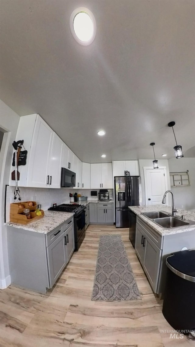 808 Adell Ave, Filer, ID 83328 - kitchen with a sink, gray cabinets, black appliances, and light wood-style flooring