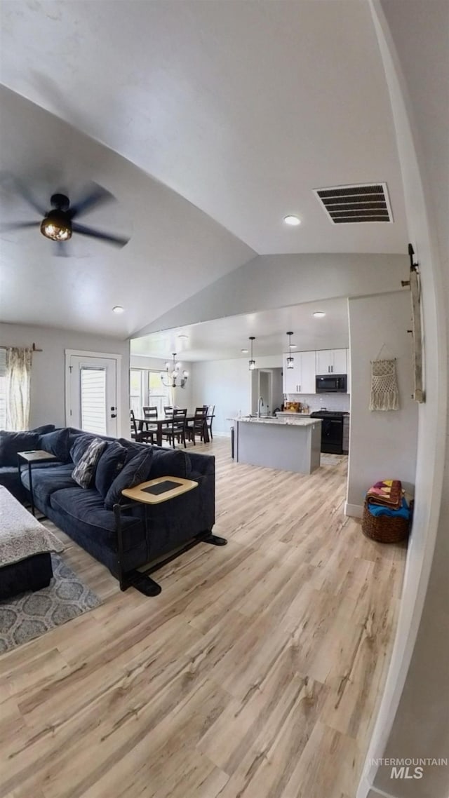 808 Adell Ave, Filer, ID 83328 - living area featuring visible vents, a ceiling fan, light wood finished floors, and lofted ceiling
