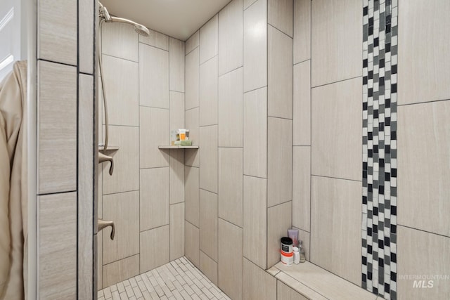 bathroom with a tile shower