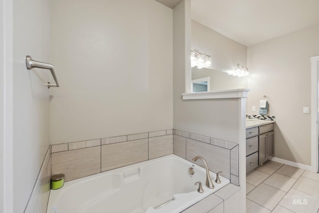 full bath featuring a bath, baseboards, and vanity
