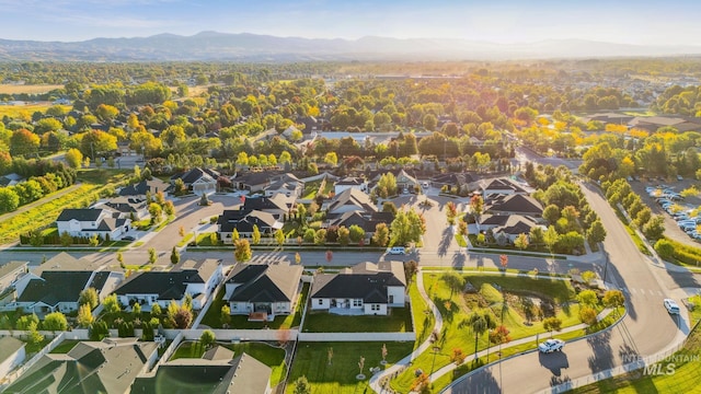 drone / aerial view featuring a residential view and a mountain view