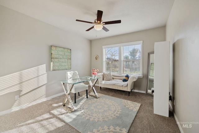 office space featuring carpet flooring, a ceiling fan, and baseboards