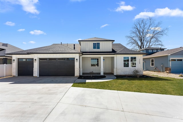 4469 E Wingate Ct, Nampa, ID 83687 - view of front of home with board and batten siding, an attached garage, concrete driveway, a front lawn, and a shingled roof