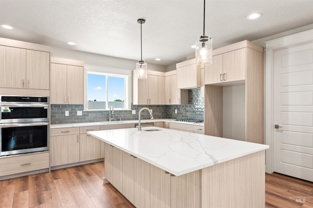 4469 E Wingate Ct, Nampa, ID 83687 - kitchen featuring appliances with stainless steel finishes, light brown cabinetry, a sink, recessed lighting, and a textured ceiling
