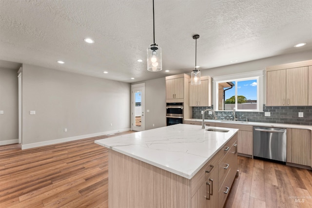 4469 E Wingate Ct, Nampa, ID 83687 - kitchen featuring stainless steel appliances, light brown cabinetry, a textured ceiling, recessed lighting, and baseboards
