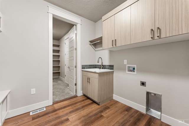 4469 E Wingate Ct, Nampa, ID 83687 - washroom featuring hookup for an electric dryer, cabinet space, dark wood-type flooring, baseboards, and washer hookup
