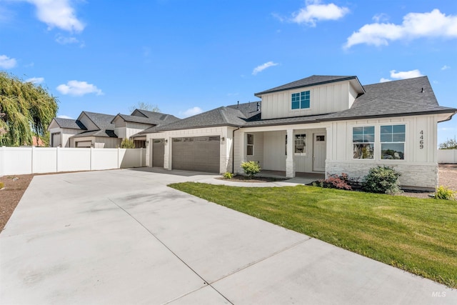 4469 E Wingate Ct, Nampa, ID 83687 - modern farmhouse style home with board and batten siding, stone siding, an attached garage, concrete driveway, and covered porch