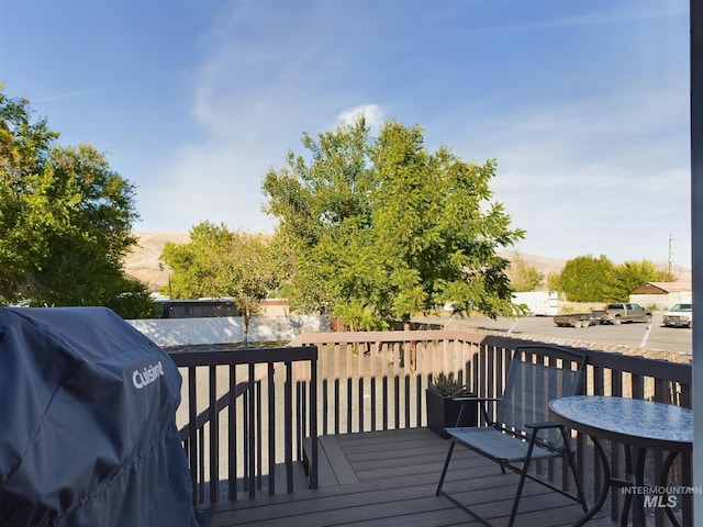 wooden terrace featuring a grill