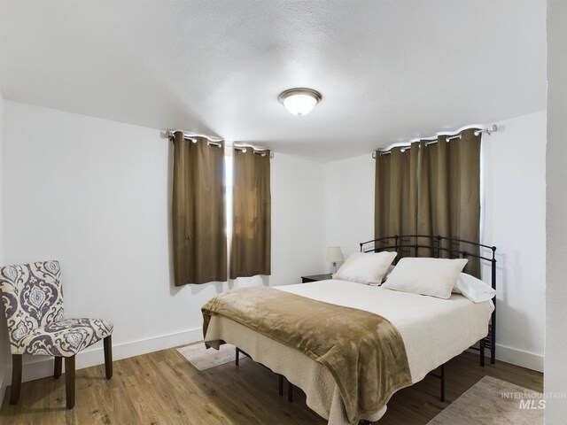 bedroom with hardwood / wood-style floors