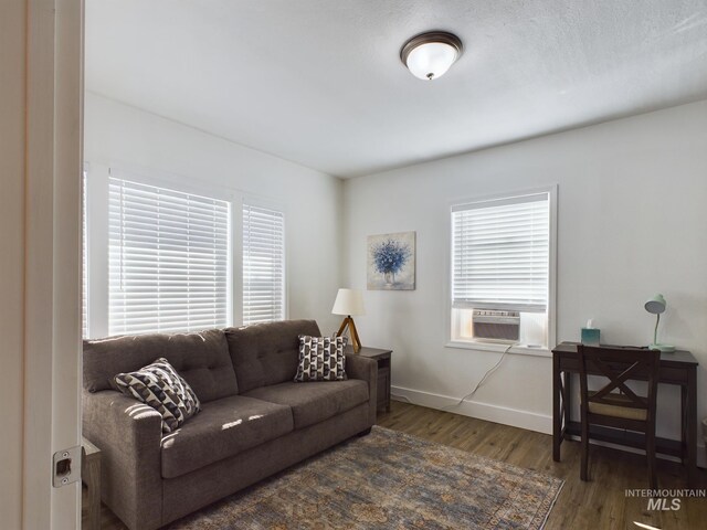 living room with cooling unit and dark hardwood / wood-style floors