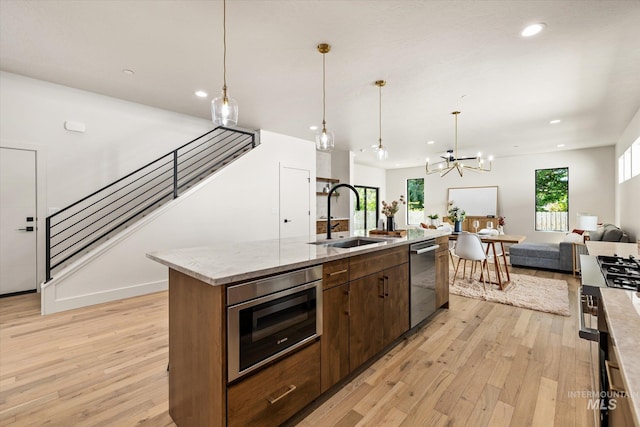 1796 S Eagleson Rd, Boise, ID 83705 - kitchen with a sink, open floor plan, appliances with stainless steel finishes, light wood-style flooring, and recessed lighting