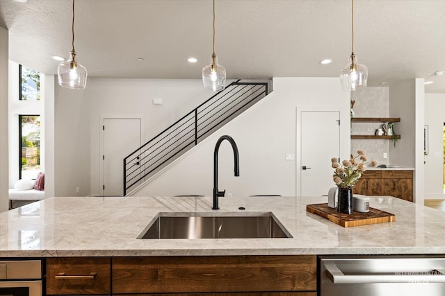 1796 S Eagleson Rd, Boise, ID 83705 - kitchen with a sink, stainless steel dishwasher, recessed lighting, light stone counters, and decorative light fixtures