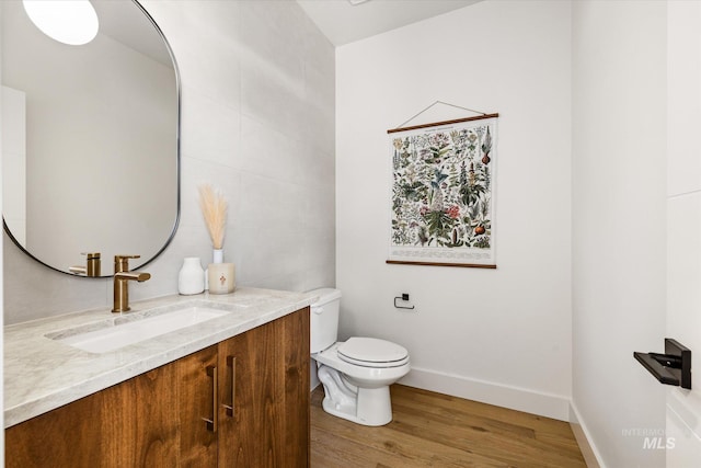 1796 S Eagleson Rd, Boise, ID 83705 - bathroom featuring wood finished floors, vanity, toilet, and baseboards