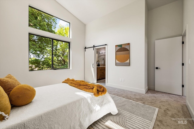 1796 S Eagleson Rd, Boise, ID 83705 - carpeted bedroom featuring high vaulted ceiling, a barn door, baseboards, and ensuite bath