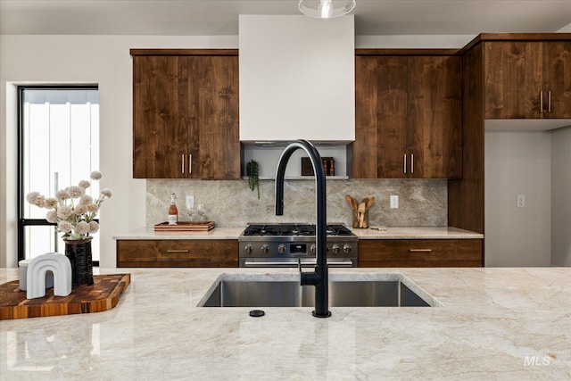 1796 S Eagleson Rd, Boise, ID 83705 - kitchen with high end stainless steel range, tasteful backsplash, dark brown cabinetry, light stone counters, and plenty of natural light