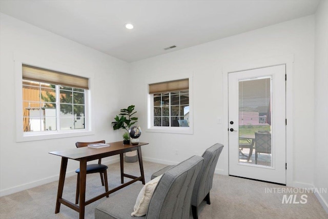 home office featuring baseboards, visible vents, and light colored carpet