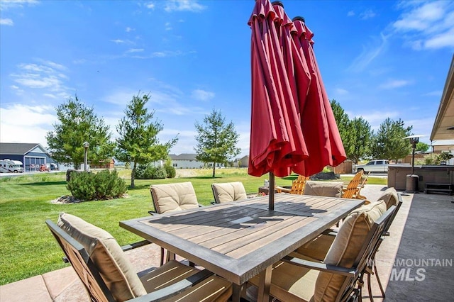 view of patio featuring a hot tub and outdoor dining area