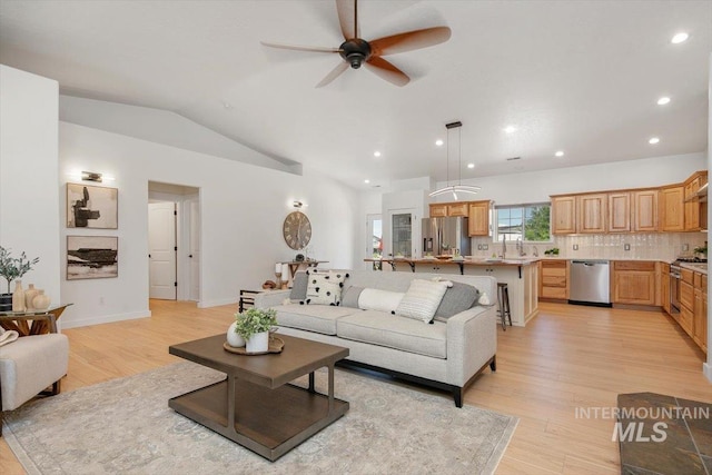 living room featuring vaulted ceiling, ceiling fan, recessed lighting, and light wood-style floors