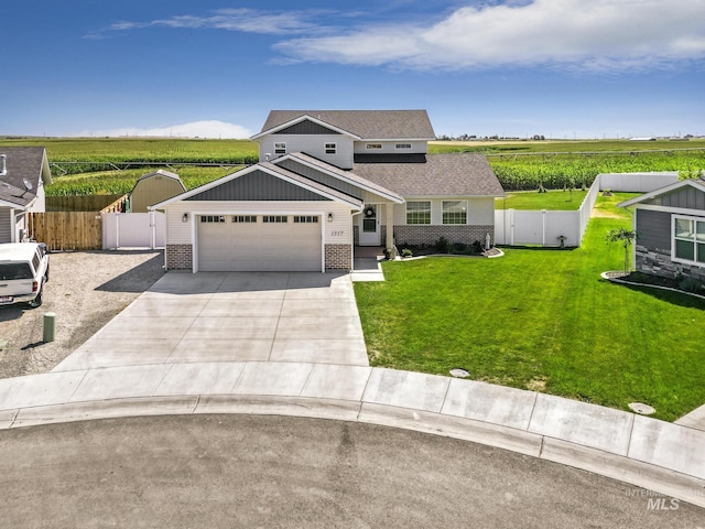 1317 Kyla Ct, Jerome, ID 83338 - view of front facade featuring brick siding, driveway, a rural view, agricultural area, and an attached garage