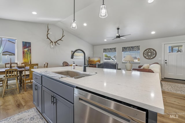 1317 Kyla Ct, Jerome, ID 83338 - kitchen with stainless steel dishwasher, a sink, open floor plan, a center island with sink, and vaulted ceiling