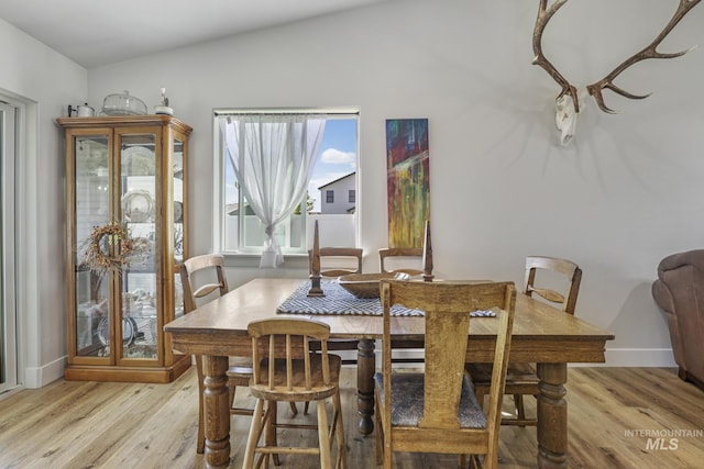 1317 Kyla Ct, Jerome, ID 83338 - dining room with light wood-type flooring, baseboards, and vaulted ceiling