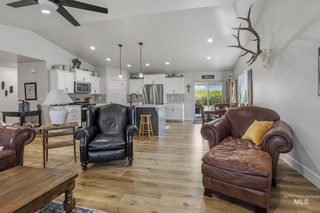 1317 Kyla Ct, Jerome, ID 83338 - living area featuring vaulted ceiling, ceiling fan, recessed lighting, light wood-style floors, and baseboards
