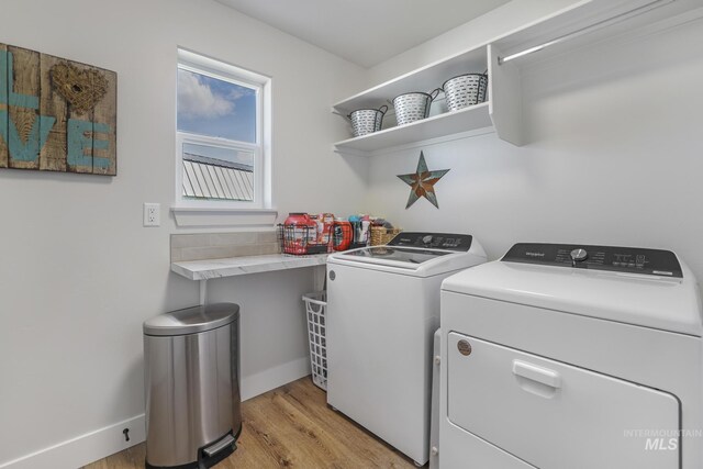 1317 Kyla Ct, Jerome, ID 83338 - laundry area featuring washer and clothes dryer, light wood finished floors, and baseboards