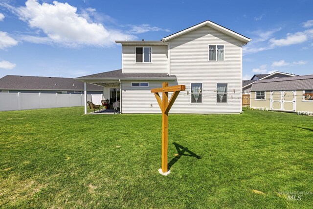 1317 Kyla Ct, Jerome, ID 83338 - rear view of property with an outbuilding, a storage shed, and a patio