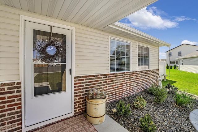 1317 Kyla Ct, Jerome, ID 83338 - doorway to property featuring brick siding and a lawn