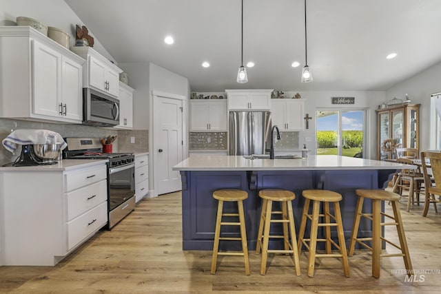 1317 Kyla Ct, Jerome, ID 83338 - kitchen with appliances with stainless steel finishes, a sink, white cabinetry, light countertops, and light wood finished floors