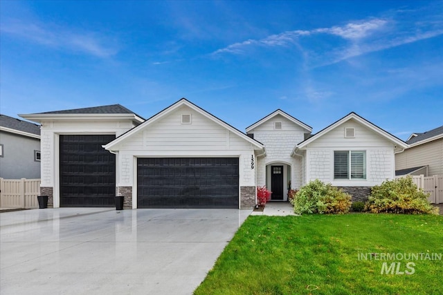 view of front of house with a front yard and a garage