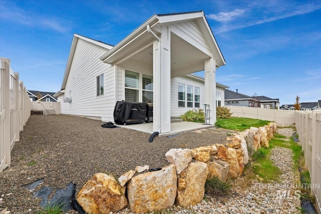 back of house with a patio and a fenced backyard
