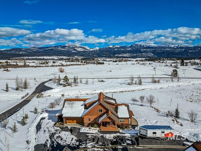 snowy aerial view featuring a mountain view