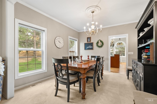 dining room with light carpet, visible vents, a chandelier, and ornamental molding