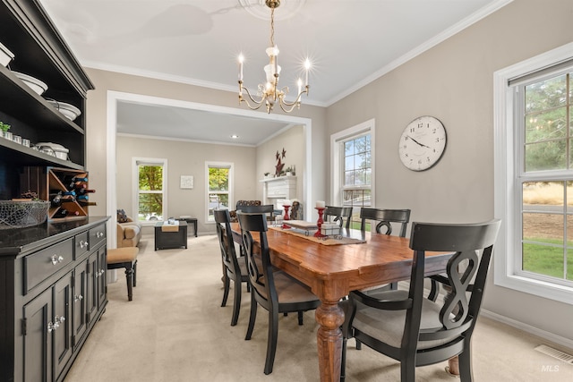 dining area featuring visible vents, light colored carpet, ornamental molding, a fireplace, and a chandelier