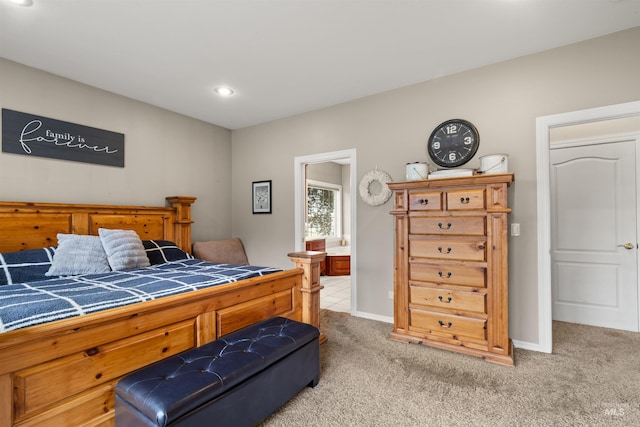 bedroom with light carpet, ensuite bath, baseboards, and recessed lighting