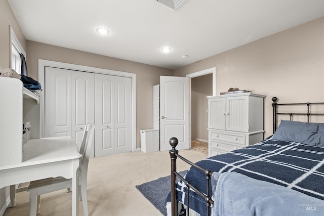 bedroom with a closet, recessed lighting, visible vents, and light colored carpet