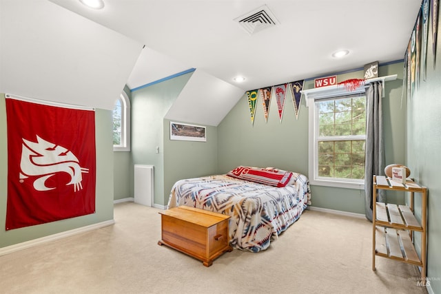 carpeted bedroom featuring lofted ceiling, visible vents, baseboards, and multiple windows