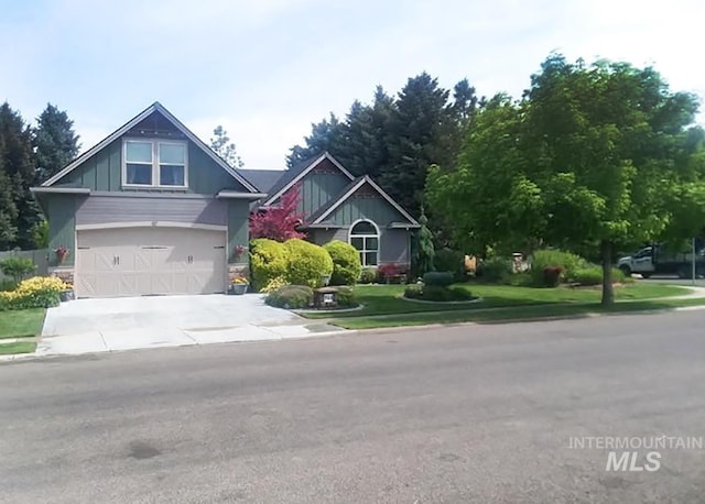 view of front of property with a garage, concrete driveway, and a front yard