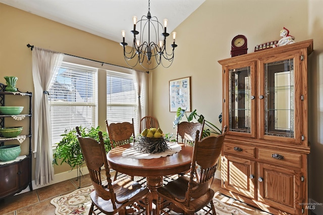 tiled dining area with lofted ceiling and an inviting chandelier