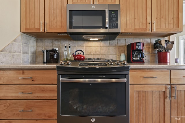 kitchen with appliances with stainless steel finishes, light countertops, backsplash, and light brown cabinets