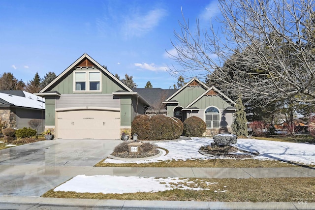 craftsman inspired home featuring board and batten siding, driveway, and a garage