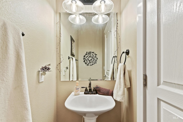 bathroom with a sink and a textured wall