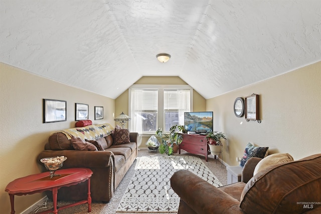 carpeted living area featuring lofted ceiling, baseboards, a textured ceiling, and a textured wall