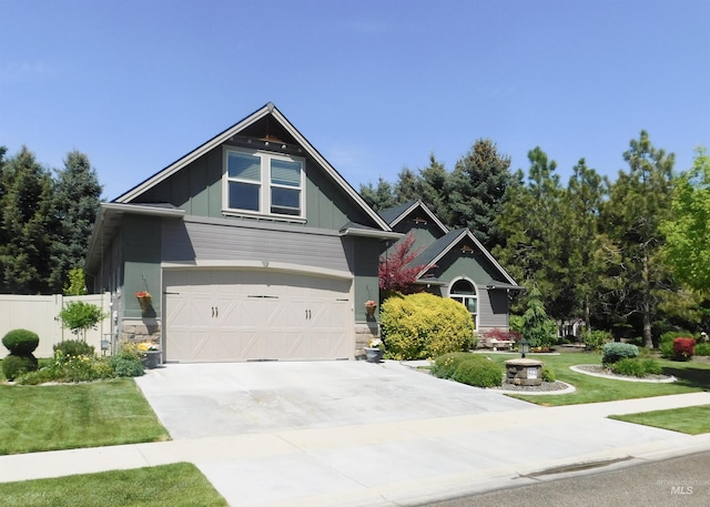 craftsman house with driveway, a garage, fence, a front lawn, and board and batten siding